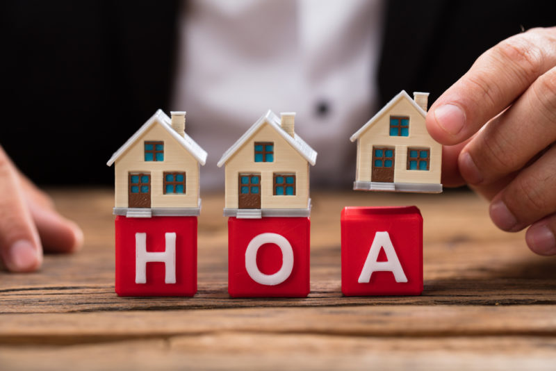 HOA with homes on top of the letters HOA